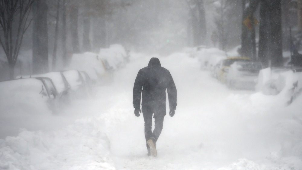 The winter storm dumped nearly 60cm of snow on the suburbs of Washington, DC, on Saturday [Carlos Barria/Reuters]