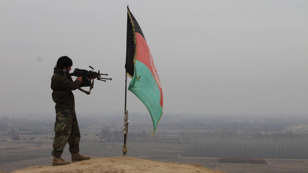 A member of the Afghan security forces takes up a position during an operation against Taliban fighters in Chardara district of Kunduz [EPA]
