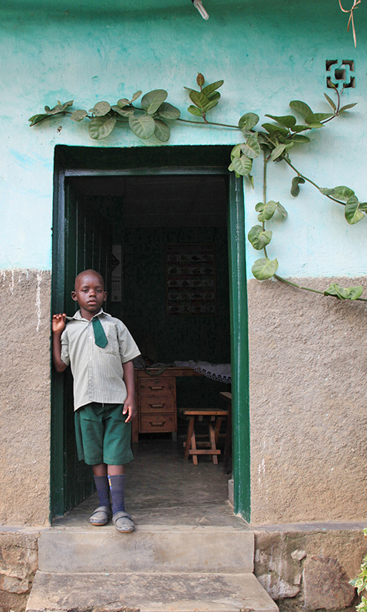 Solomon in school uniform at his new home [Anais Lopez/Al Jazeera]