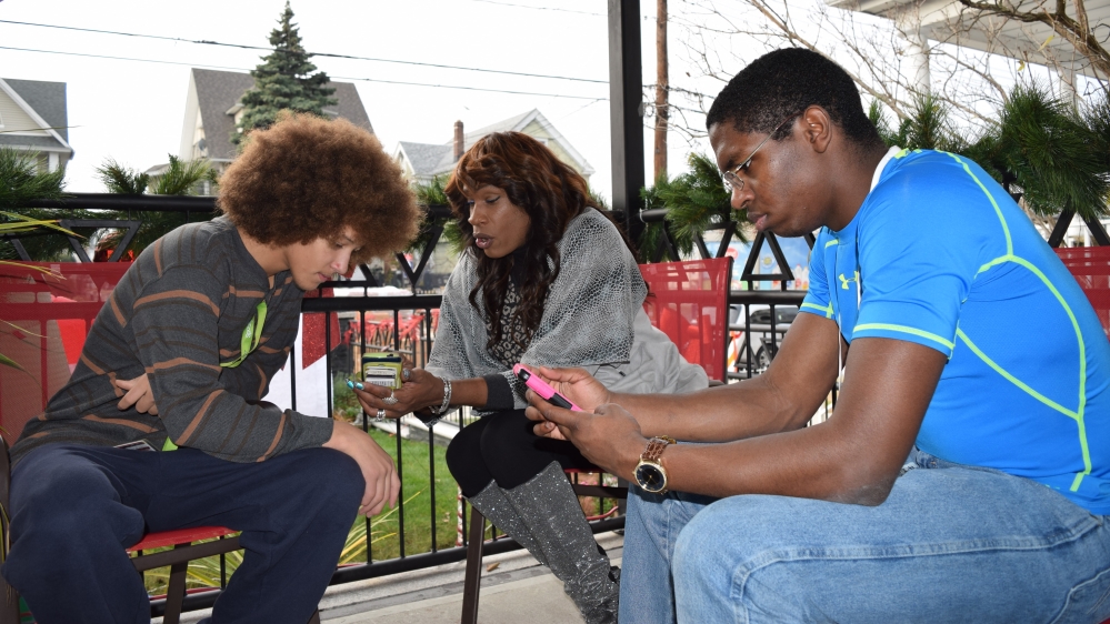 Doroshow sits with volunteers at The River Fund volunteers. The food pantry has reached members of the transgender community who know they'll be welcomed [Lene Bech Sillesen/Al Jazeera]