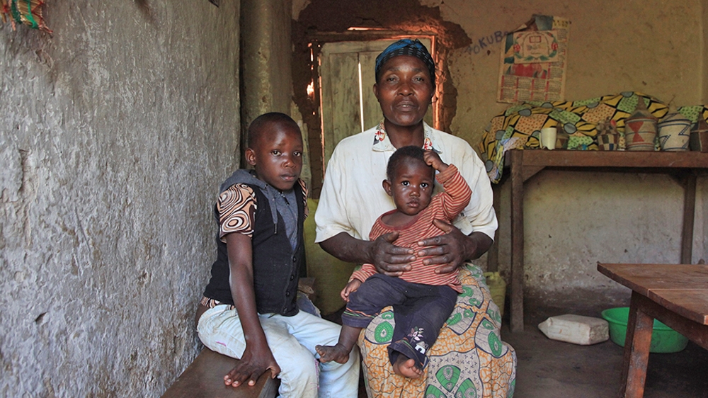 Samuel is now living with his grandmother. She is also taking care of Carine, the baby of her other daughter, who died just weeks after Samuel was placed back with the family [Anais Lopez/Al Jazeera] 