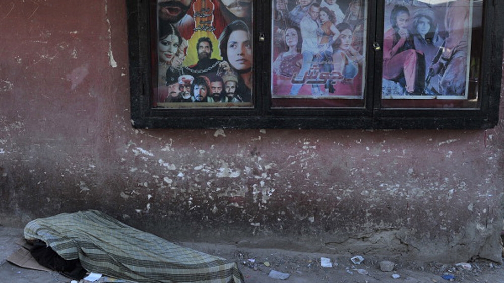 An Afghan man rests near a cinema in Kabul [AFP]