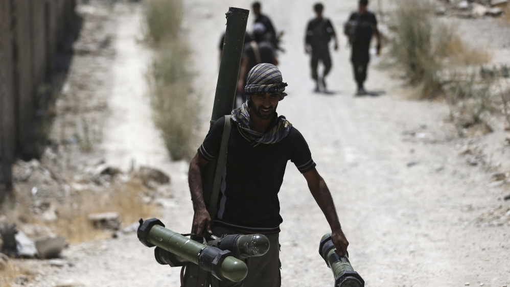 File photo of Free Syrian Army'' fighter carrying a weapon as he walks towards his position on the frontline against the forces of Syria''s President Assad in Jobar, a suburb of Damascus.