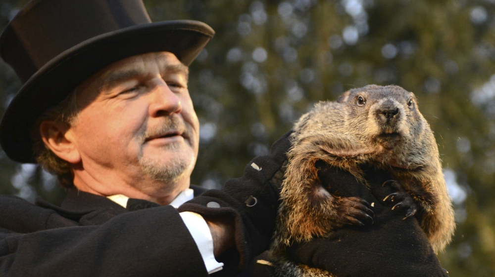 Groundhog co-handler Griffiths holds up groundhog Punxsutawney Phil after Phil''s annual weather prediction on Gobbler''s Knob on the 130th Groundhog Day in Punxsutawney