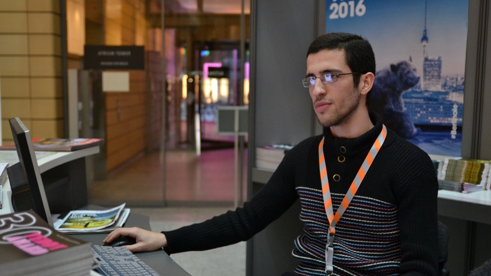 Mohammad Dowwah didn't expect to be volunteering at one of the world's largest cinema festivals only a year later after his arrival in Germany [Kait Bolongaro/Al Jazeera]
