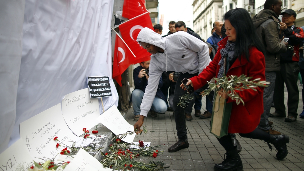 Tourists leave olive branches at the explosion site in Istanbul