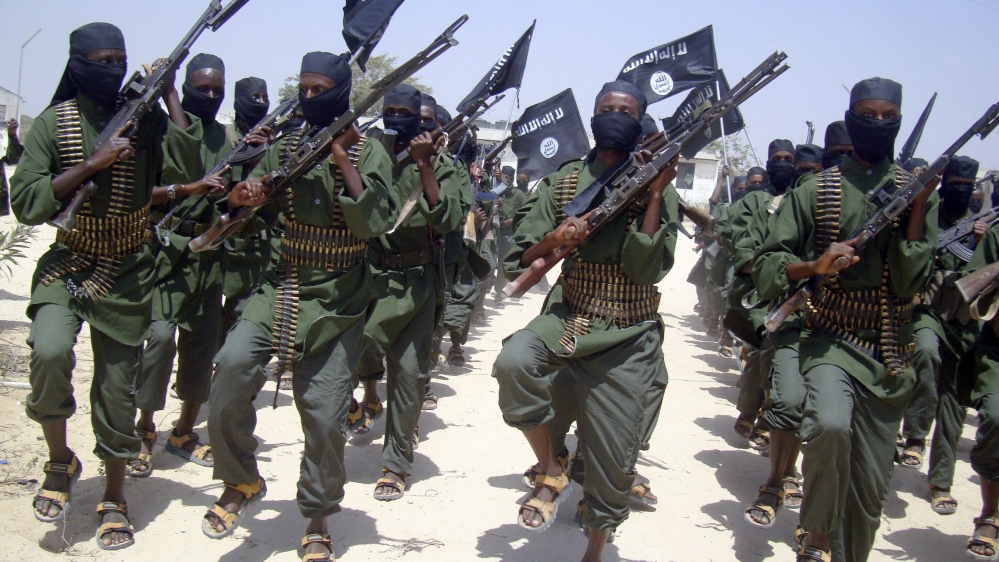 Al-Shabab fighters march with their weapons during military exercises on the outskirts of Mogadishu, Somalia [AP]
