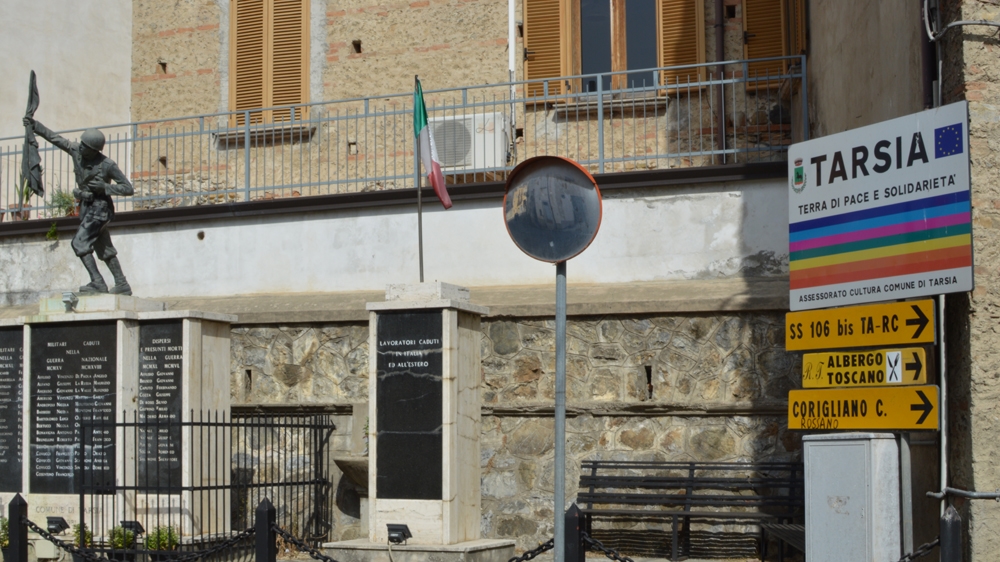 Sign in Tarsia that reads: 'A land of peace and solidarity'  [Rosie Scammell/Al Jazeera] 