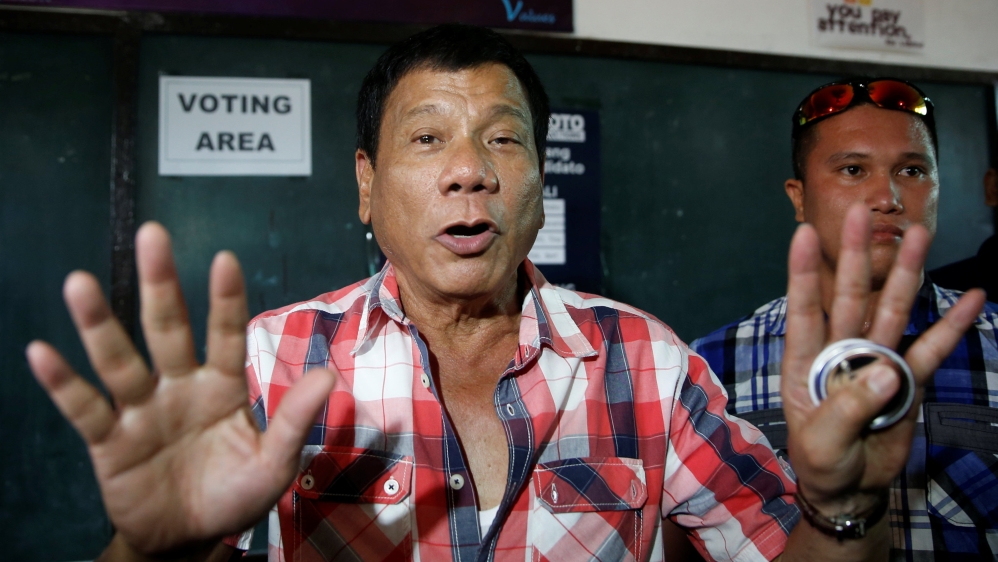 Presidential candidate Rodrigo "Digong" Duterte talks to the media before casting his vote at a polling precinct for national elections at Daniel Aguinaldo National High School in Davao
