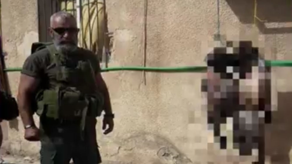 Issam Zahreddine allegedly posing next to mutilated corpses [Screenshot from social media]