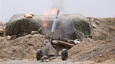 Fighters of the Syria Democratic Forces fire a mortar shell towards positions held by ISIL in Raqqa, Syria [REUTERS]