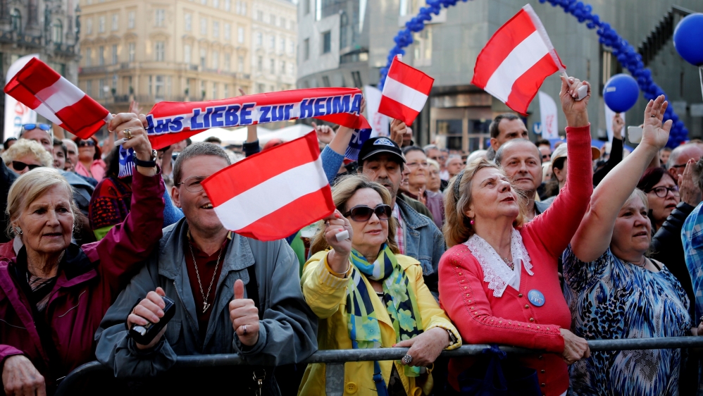 Austrian Freedom Party supporters wave flags in Vienna