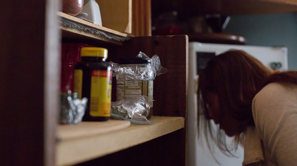  Becca's shelves are full of holistic herbal remedies meant to help her mental and physical wellbeing  [Carolyn Bick/Al Jazeera] 