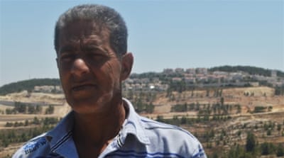 Omar Halajay's home has been isolated from the rest of his community, but he has a clear view of the illegal Israeli settlement of Gilo from his front porch [Sheren Khalel/Al Jazeera]