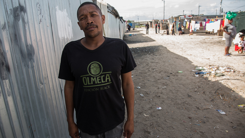 
Alvin Johnson in Blikkiesdorp. Evicted from Gympie Street in Woodstock eight years ago, Johnson likens Blikkiesdorp to a 'concentration camp' [Shaun Swingler/Al Jazeera]
