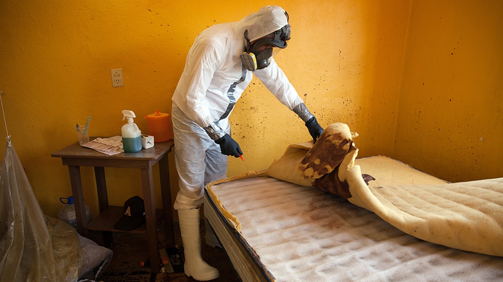 Donovan carries out a forensic cleaning of the scene of an unsolved homicide in Cuernavaca, Morelos [Benedicte Desrus/Al Jazeera]