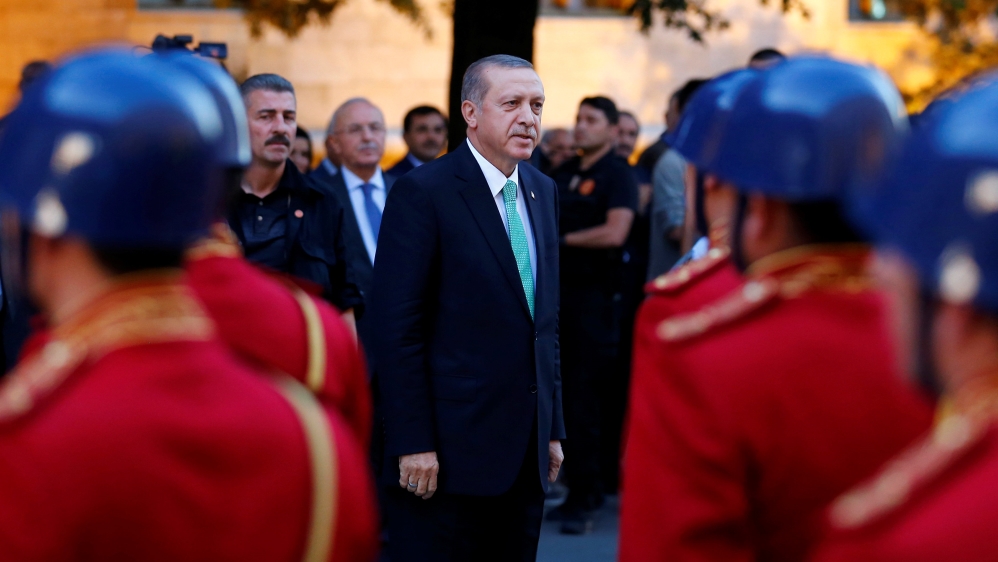 Turkish President Tayyip Erdogan reviews a guard of honour as he arrives to the Turkish Parliament in Ankara