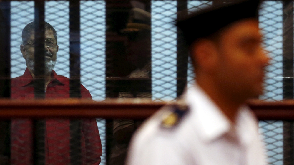 Deposed President Mohamed Mursi is seen behind bars at a court