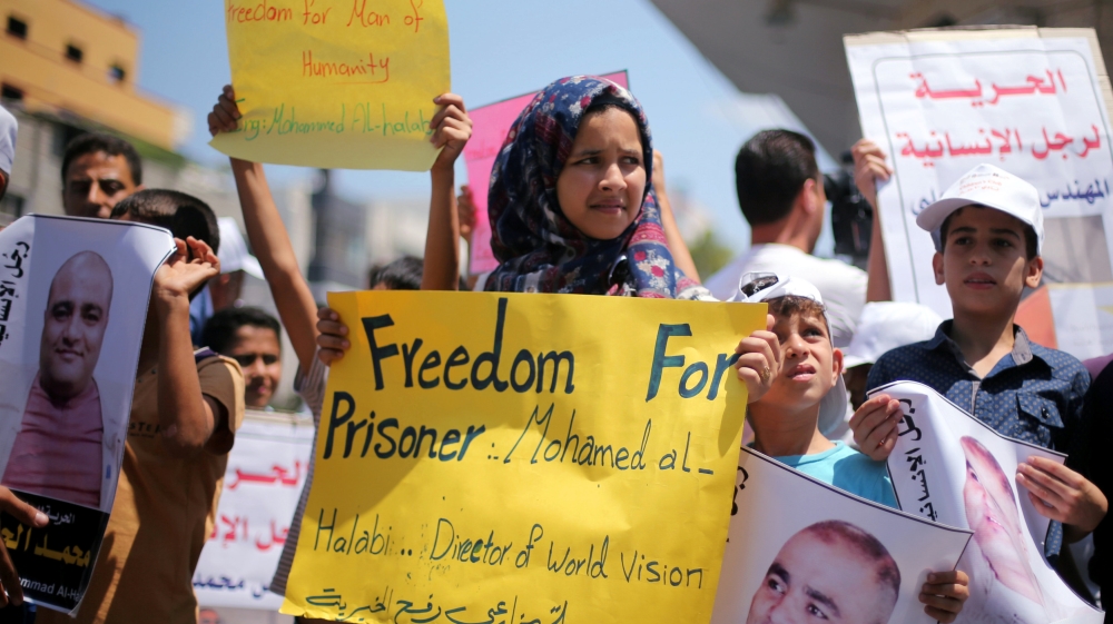Palestinian demonstrators take part in a protest in solidarity with Mohammad El Halabi, World Vision''s manager of operations in Gaza, organised by foundations and societies benefiting from World Visi
