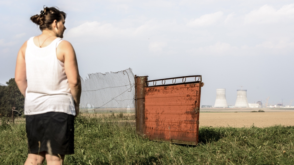 Theresa looks out across the fields towards the nuclear power plant under construction - 'Before it used to be all forest' [   Benas Gerdziunas   /Al Jazeera]  
