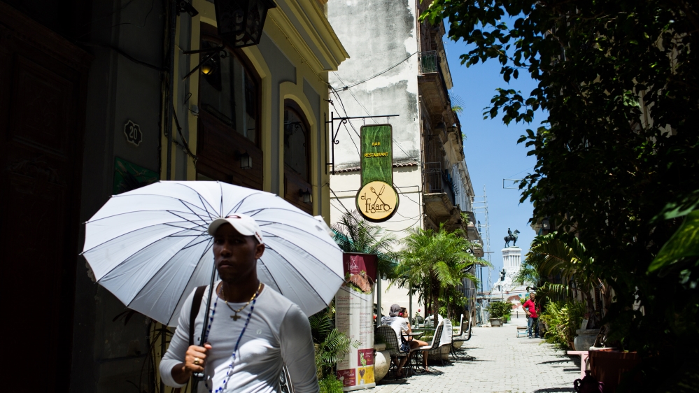 A man walks by the Callejon de los Peluqueros (“Hairdressers’ Alley”) on September 3, 2016 [Al Jazeera]