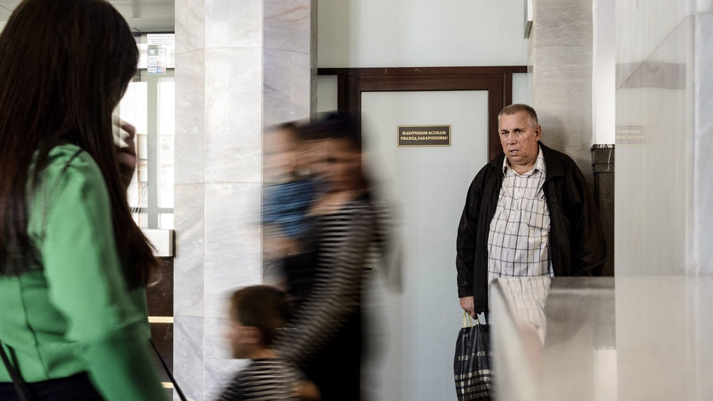An anxious family, who didn't try to cross into Poland that day, watches Chechen families return to Brest after being refused entry at the Polish border [Ben Gerdziunas/Al Jazeera] 