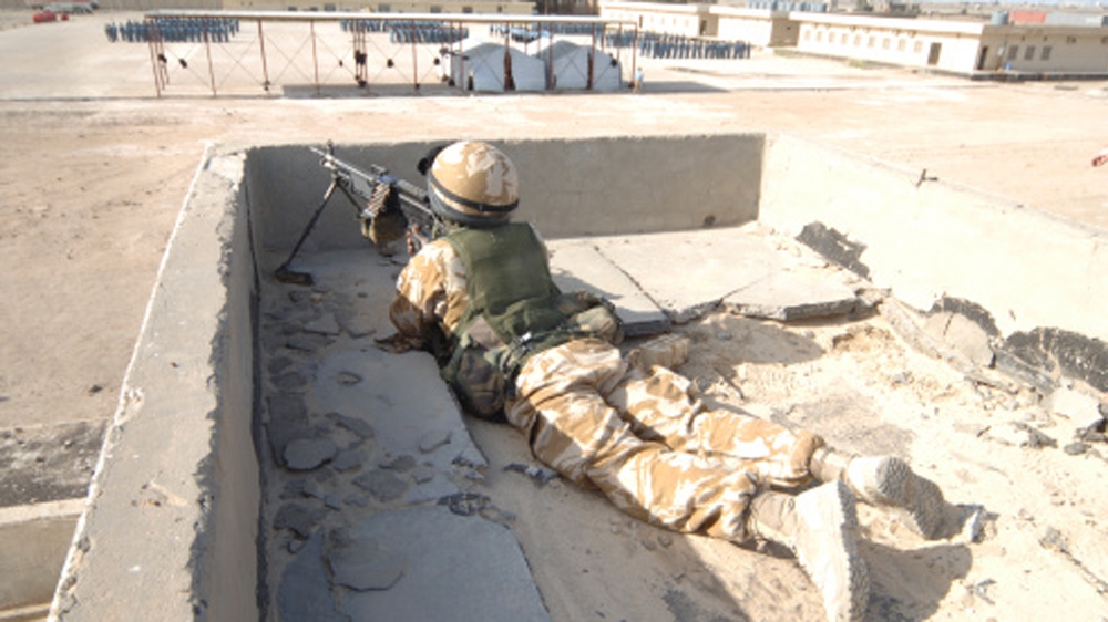 A British soldier provides security from a rooftop in Basra, Iraq [Getty]