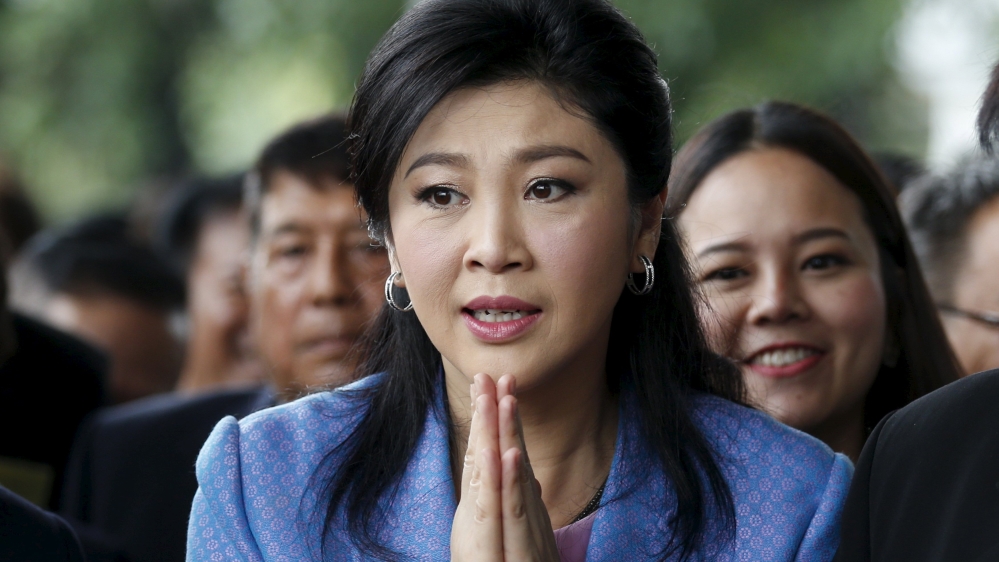 Ousted former Thai Prime Minister Yingluck Shinawatra gestures as she arrives at the Supreme Court in Bangkok