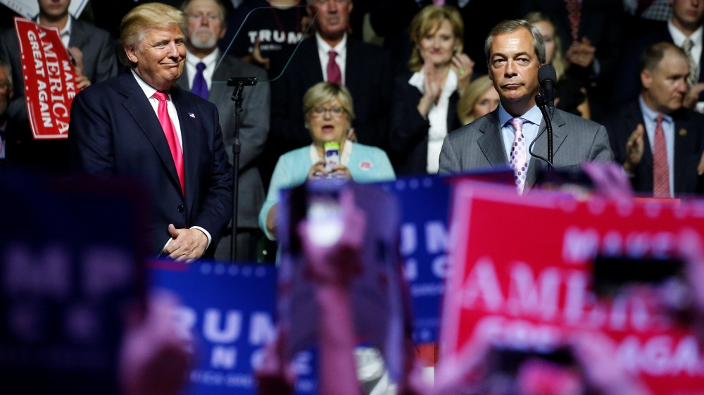 Republican presidential nominee Donald Trump watches as Member of the European Parliament Nigel Farage speaks at a campaign rally in Jackson
