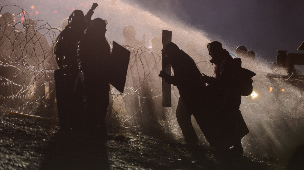 Police use a water cannon on protesters during a protest against plans to pass the Dakota Access pipeline near the Standing Rock Indian Reservation, near Cannon Ball, North Dakota, U.S.