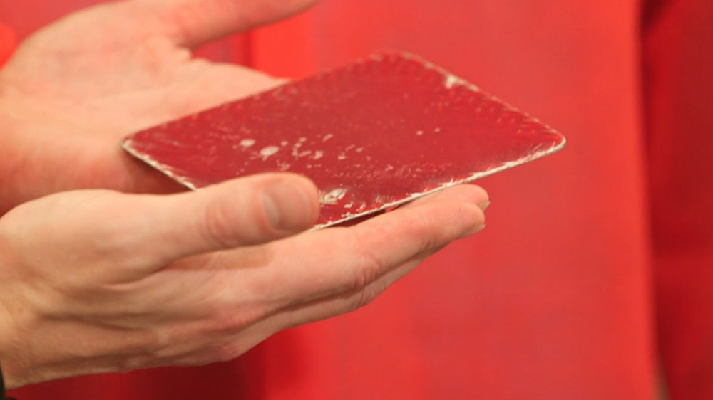 To feed the mosquitoes, Oxitec scientists put blood on a plate, then a heating pad on top. The heat attracts the mosquitoes to the plate and they begin to feed [Al Jazeera]