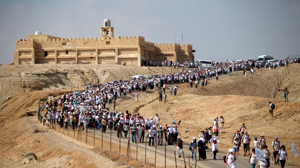 Demonstrators including Israeli and Palestinian activists take part in a demonstration in support of peace near the West Bank city of Jericho