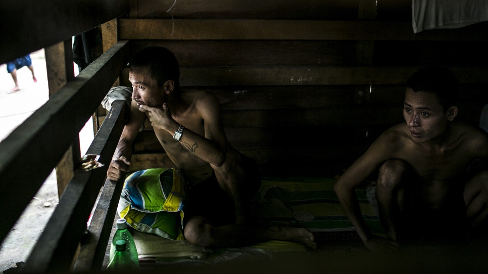 
Two recent arrivals endure the hot and small 'detox room', which they are not allowed to leave for up to two weeks while going through the initial stages of withdrawal [David Shaw/Al Jazeera]
