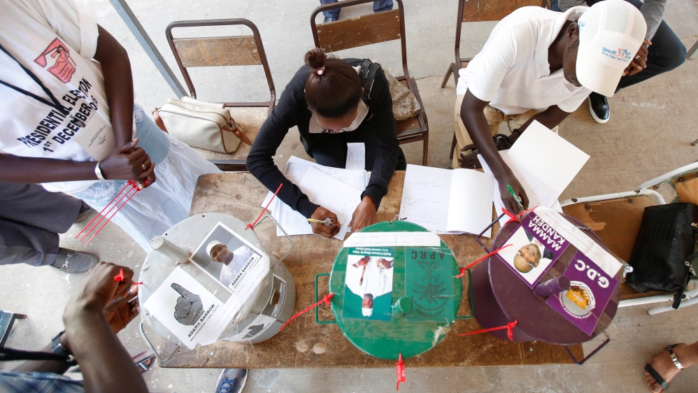 Voters placed marbles into drums marked for each candidate [Thierry Gouegnon/Reuters]