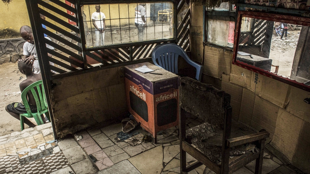 Kris Bitenda, a barber and tattoo artist, owns this barbershop in the Lubugi district, in Kinshasa  [Francesca Volpi/Al Jazeera]