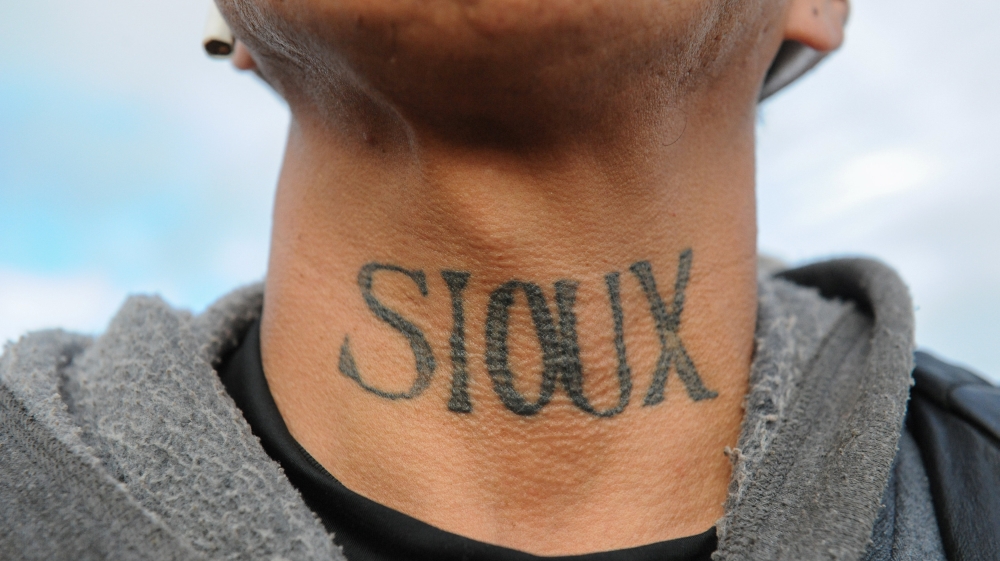 A man from the Lakota Sioux tribe with a Native American tattoo on his neck poses for a photograph during a protest against plans to pass the Dakota Access pipeline near the Standing Rock Indian Reser