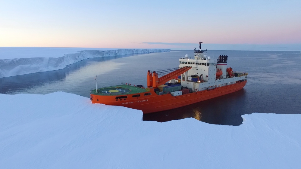 The ship's captain spots a sheltered cove and, after careful inspection, runs the bow of the ship up against the ice [Tarek Bazley/Al Jazeera]