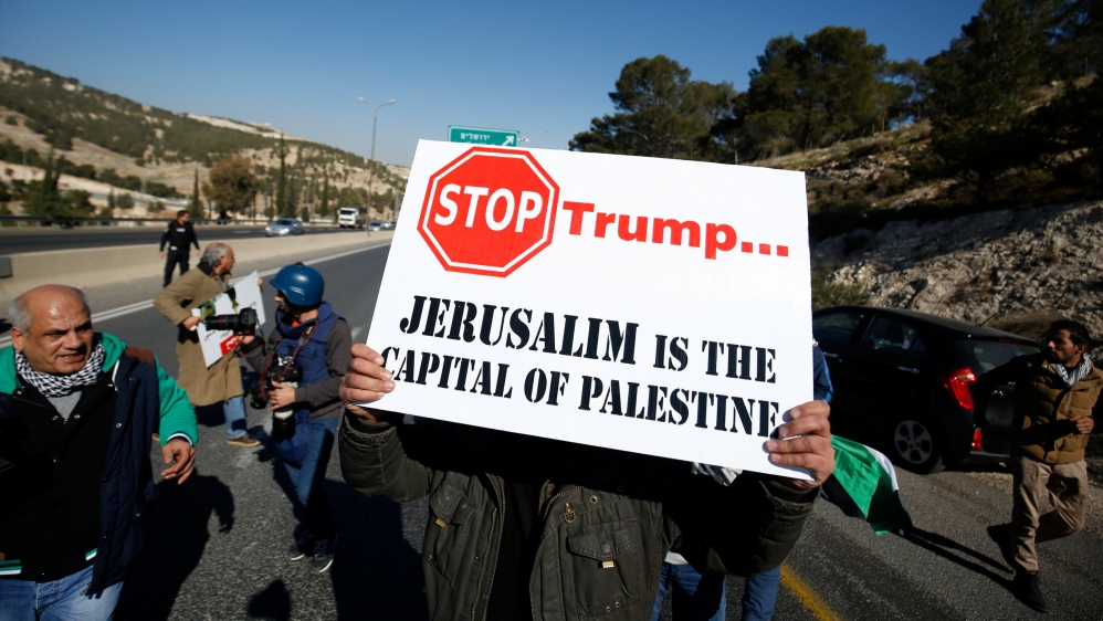 Palestinian demonstrator holds placard during a protest against a promise by U.S. President-elect Donald Trump to re-locate U.S. embassy to Jerusalem, in t