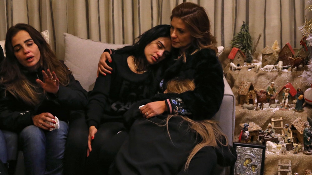 Sisters of Wardini mourn at their home in Beirut [Hussein Malla/AP]