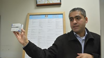 Talha Ahmad, a  chemotherapy pharmacist, points to a shortage of medications in Gaza  [Mersiha Gadzo/Al Jazeera]
