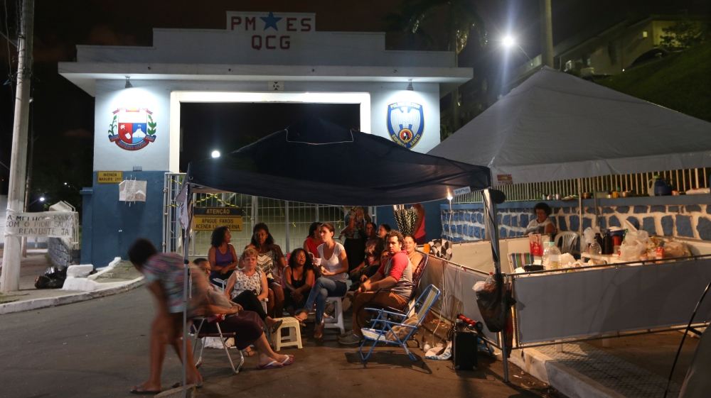 Relatives of police officers camp at the entrance of police HQ to block the main entrance during the strike [Reuters]