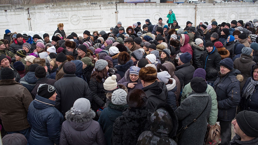 People stand in a chaotic line to register for humanitarian assistance in Avdiivka [John Wendle/Al Jazeera] 