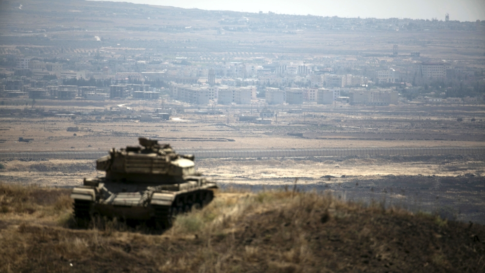 The Syrian area of Quneitra is seen in the background as an out-of-commission Israeli tank parks on a hill, near the ceasefire line between Israel and Syria, in the Israeli-occupied Golan Heights