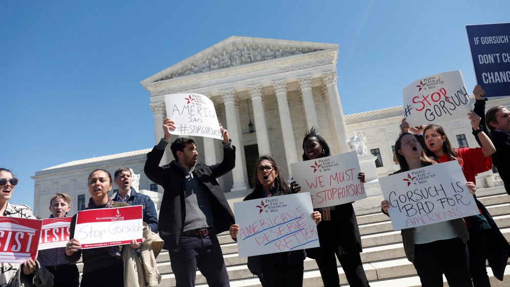 Demonstrators chant during a demonstration against Neil Gorsuch outside the Supreme Court