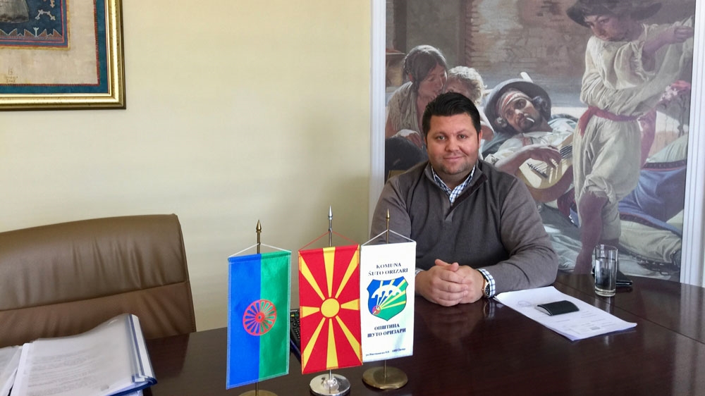 Mayor Elvis Bajram sits in his office in Shutka [Valerie Hopkins/Al Jazeera]