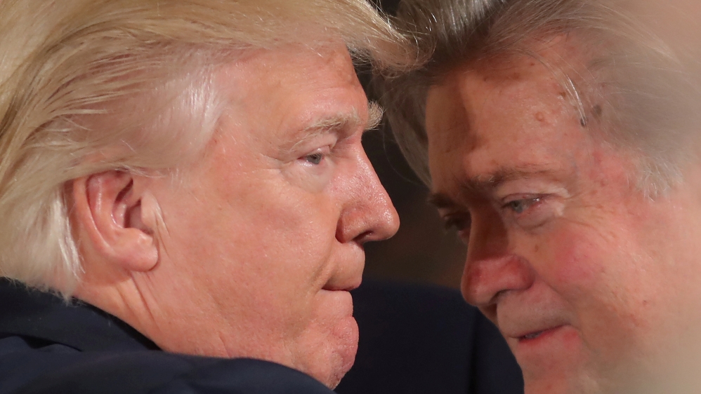 FILE PHOTO: U.S. President Donald Trump talks to senior staff Steve Bannon during a swearing in ceremony for senior staff at the White House in Washington, DC