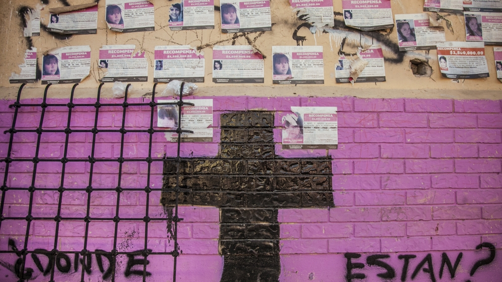 Posters of missing women and spray-painted messages cover the walls of the former Club Verde guesthouse [Gabriela Campos/Al Jazeera]