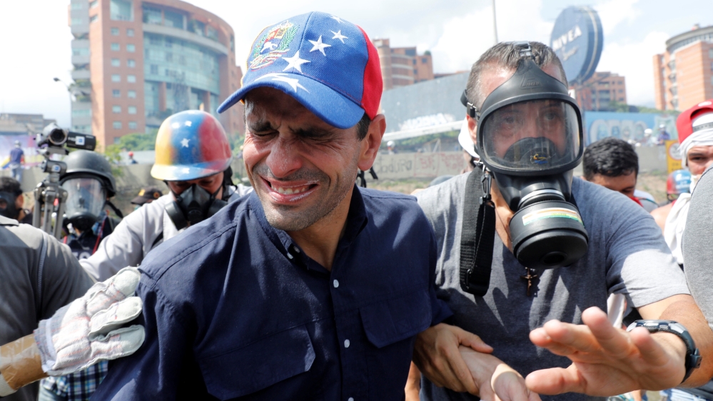 Venezuela opposition leader and Governor of Miranda state Capriles reacts as he is affected by tear gas while rallying against Venezuela''s President Maduro in Caracas