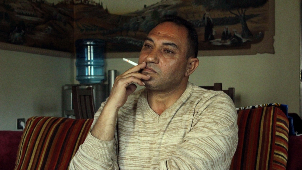 Loay Tailakh avoids seeing his children's faces, as just one video chat can leave him immobile and depressed for days [Jaclynn Ashly/Al Jazeera]