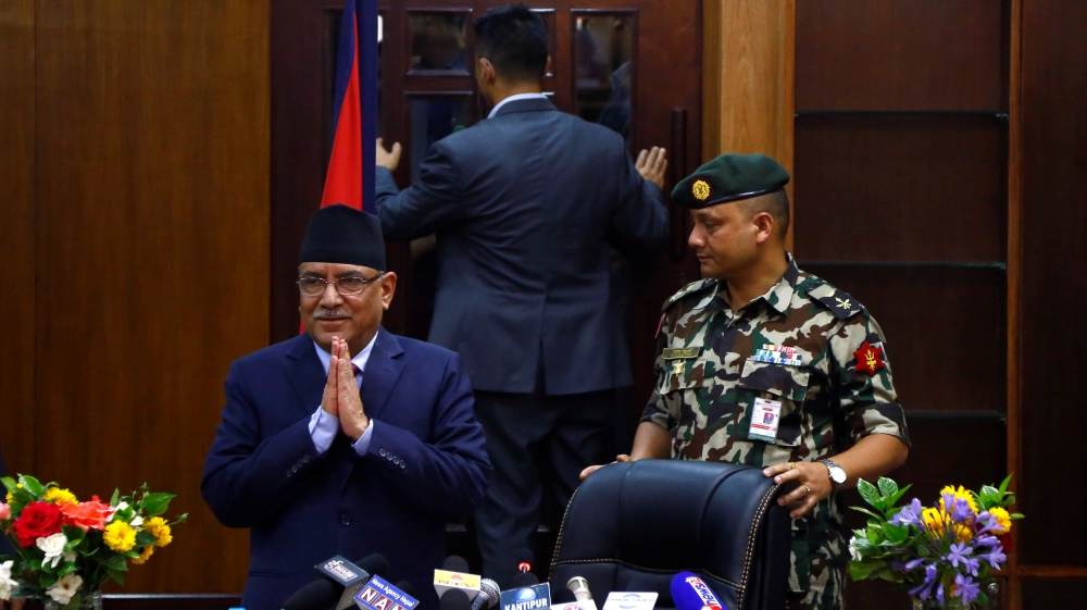 Nepalese PM Pushpa Kamal Dahal, also known as Prachanda, greets media upon his arrival to announce his resignation in Kathmandu